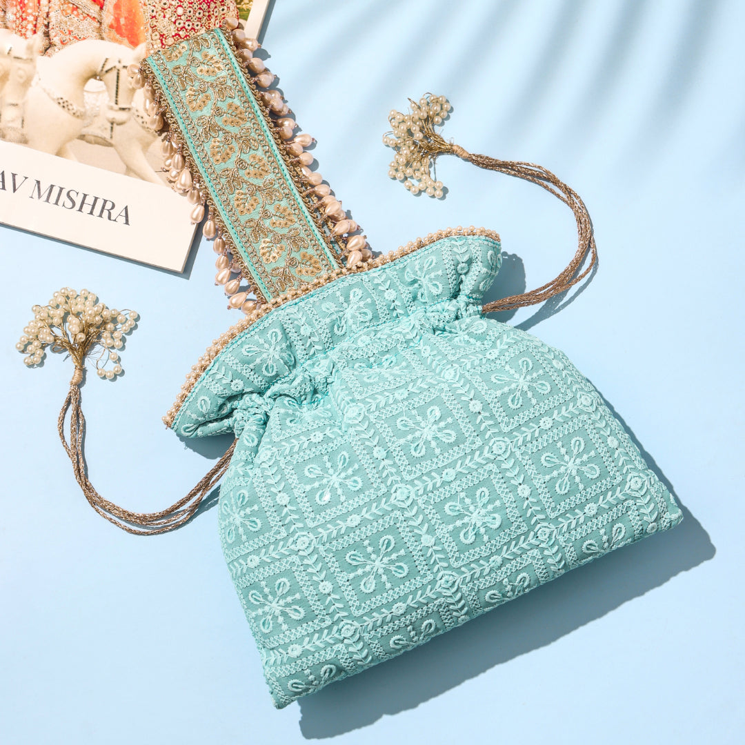 Light blue textured bag with floral patterns on a light blue background
