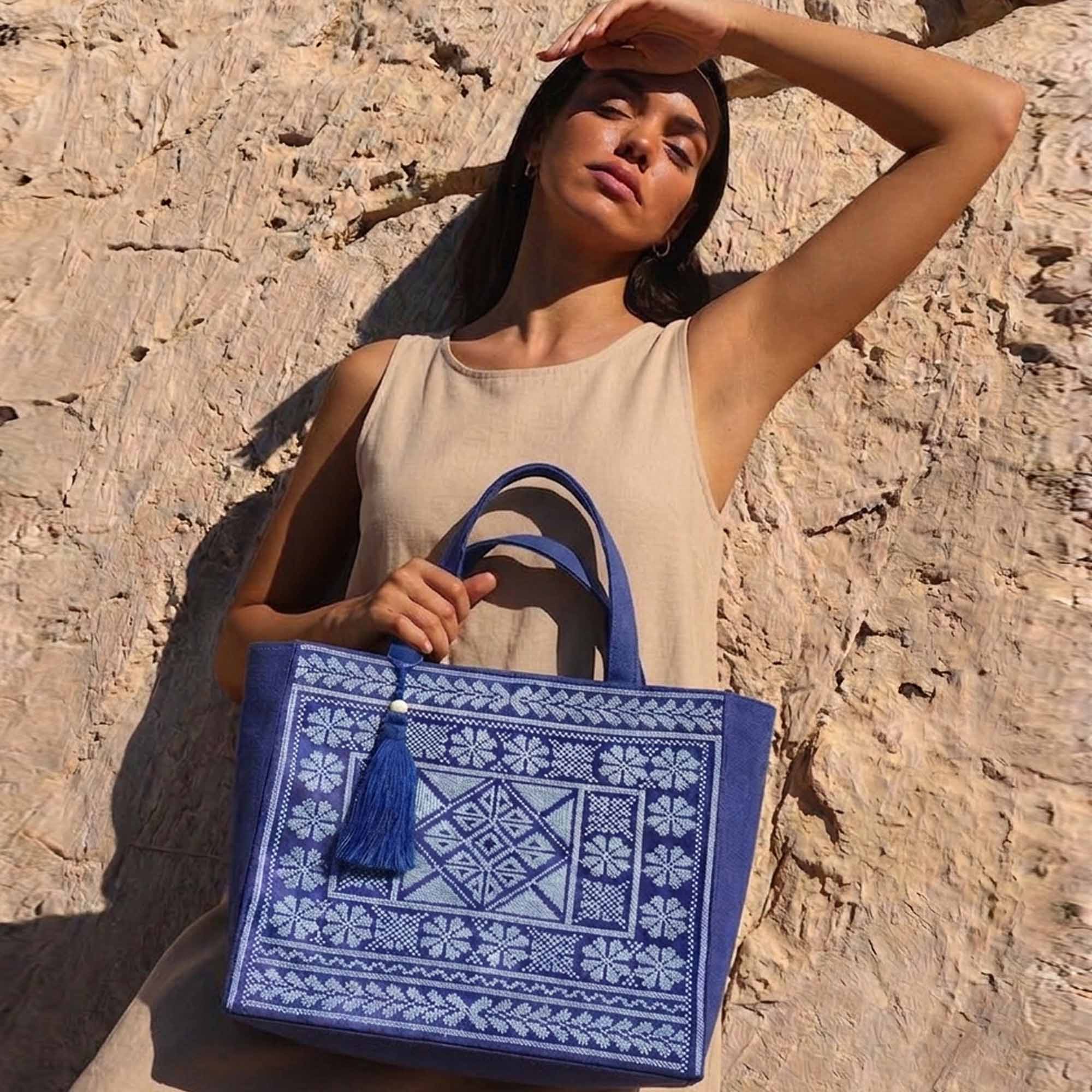 model carrying blue bag