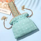 Light blue textured bag with floral patterns on a light blue background