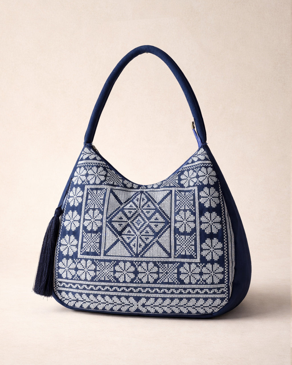 Blue and skyblue embroidered handbag on a beige background