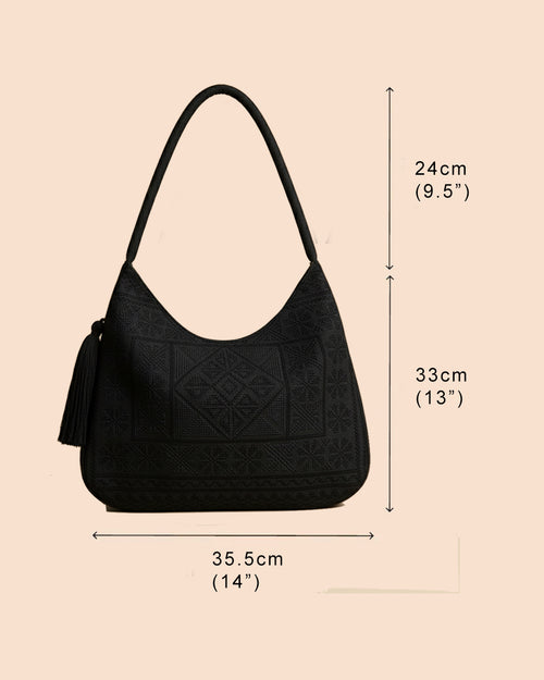 Black handbag with dimensions labeled on a beige background