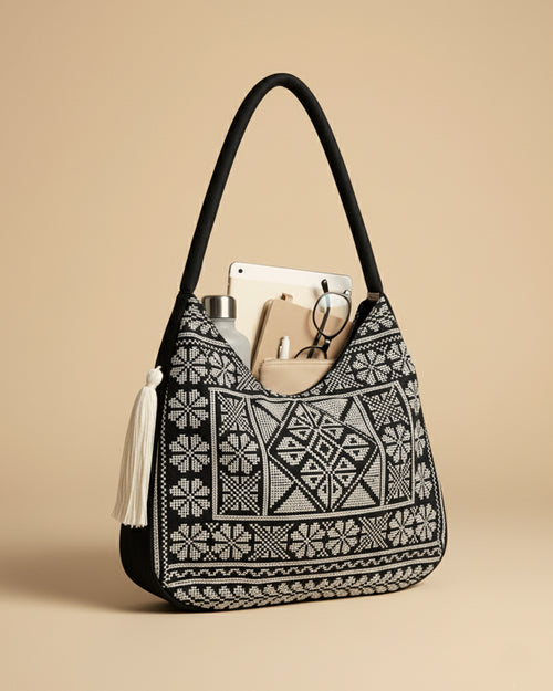 Black and white hobo patterned handbag with a beige background